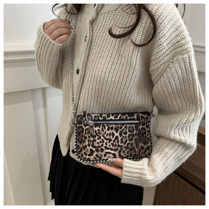 Detail of leopard print crossbody bag with silver rivets and metal chain strap