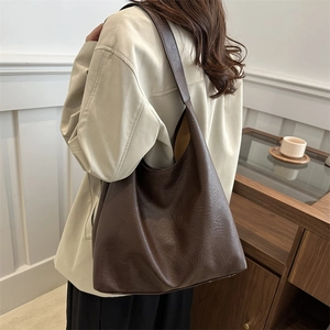 Deep brown oversized hobo shoulder bag in textured leather for casual daily commute