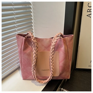 Detail of pink denim texture tote bag with fashion pocket and woven rope handle