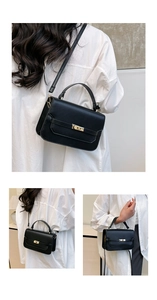 Detailed view of a black PU leather crossbody bag with golden twist lock and top handle