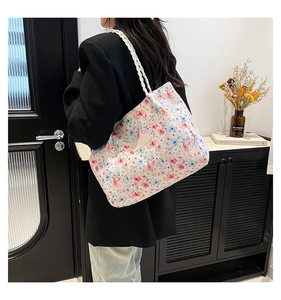 Detail of floral tote bag showing colorful patterns and sturdy woven rope handles