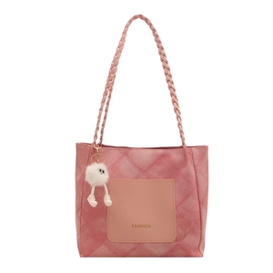 Pink quilted tote bag with woven shoulder straps and a white plush charm on white background