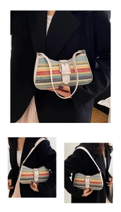 Detail of colorful striped woven straw bag with beige leather strap and metal buckle
