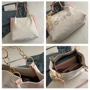 Detail view of pink and beige tote bag with cute bear print and lace bow accessory