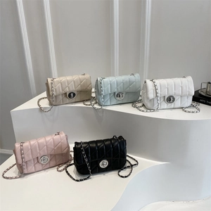 Chic quilted chain crossbody bags in five colors on a minimalist display stand