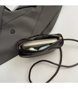 Detailed interior of glossy patent leather half moon bag showing spacious storage capacity