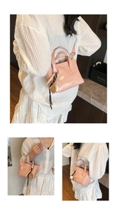 Detail of pink glossy shoulder bag with top handles and baseball charm accessory