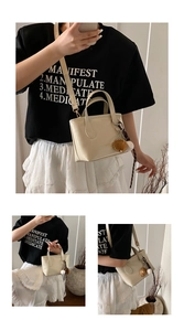 Detail of cream mini tote bag with gold lettering and adjustable shoulder strap