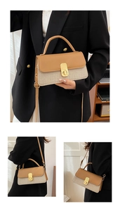 Details der Handtasche aus kamelfarbenem Leder und Webstoff mit Goldverschluss