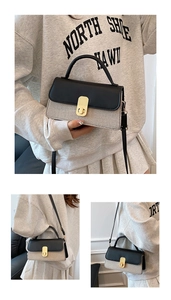 Detailansicht einer gewebten Kontrast-Handtasche mit goldenem Drehverschluss und Lederakzenten