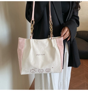 Detailed look at color-block tote bag with puppy print and metal chain leather strap