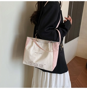 Detail view of large canvas tote bag with cute bear prints and metal ring shoulder strap