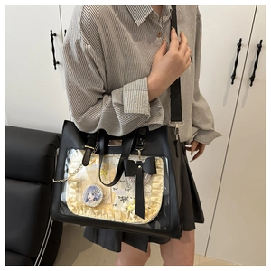Detail view of large capacity black leather Ita bag with transparent window for anime badges