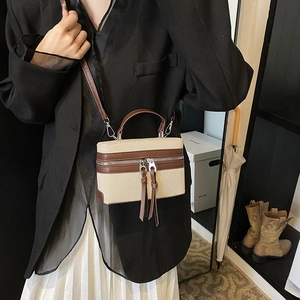 Chic canvas and brown leather box bag with long tassel zippers and top handle