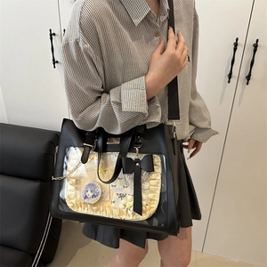 Black ita bag tote with clear PVC window and yellow ruffle decoration shown on model