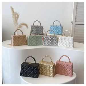 Collection of embossed box bags in nine colors featuring woven handles and chain straps