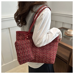 Detail view of red tweed tote bag with matching pouch and leather shoulder straps