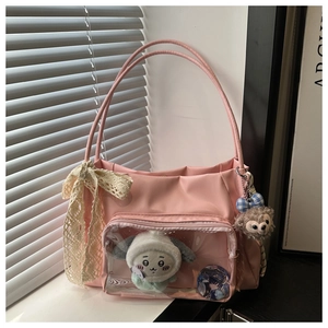 Detail of pink tote bag with transparent PVC pocket for anime badges and plush charms