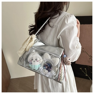 Silverita ita bag with clear window and plush toy details shown on model shoulder