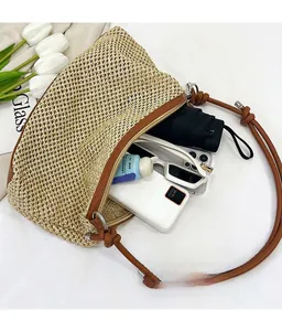 Interior view of straw crossbody bag showing large capacity for phone, umbrella, and sunglasses