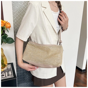 Detail of hand-woven straw tote bag with premium faux leather base and shoulder straps