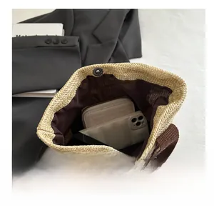 Interior view of woven straw tote bag showing spacious capacity for phone and wallet