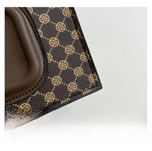 Macro view of retro monogram pattern leather with premium stitching on brown shoulder bag