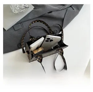 Interior view showing the capacity of this retro printed tote bag for two smartphones