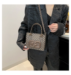Detail of printed crossbody bag with embossed G letter and geometric pattern