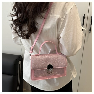 Model wearing a pink sequin crossbody bag with silver buckle and adjustable shoulder strap
