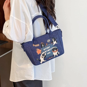 Deep blue denim tote bag featuring cute cartoon cat illustrations and sturdy handles