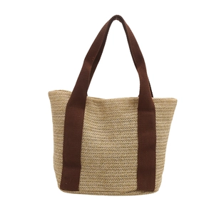 Handcrafted woven straw tote bag with brown canvas handles for women spring 2025 style