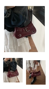 Detail of burgundy PU leather shoulder bag featuring metallic buckles and punk style eyelets