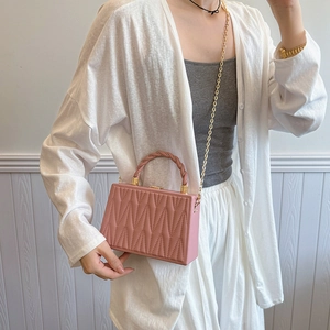 Pink quilted shoulder bag with golden chain strap and twisted top handle for women
