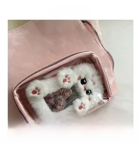 Detail of pink tote bag with transparent PVC pocket and cute plush cat card holder