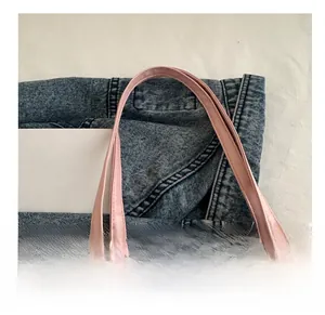 Close-up of comfortable double handles and fine stitching on the pale pink tote bag
