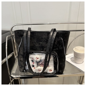Detail of black ita bag tote with transparent PVC pocket and cute plush cat doll insert