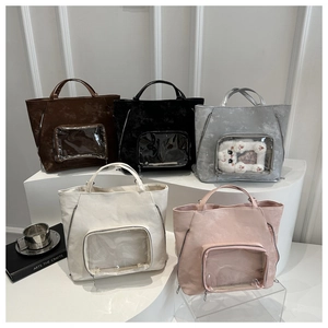 Detail view of ita bags in five colors with clear windows for displaying charms and badges