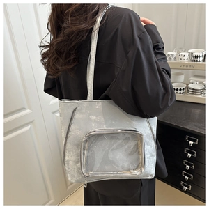 Detail of silver metallic tote bag with transparent PVC display window and stylish texture