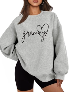 Close-up of heart and grammy print on a casual grey oversized crewneck sweatshirt