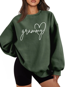 Close-up of white grammy print and heart detail on dark green thick cotton sweatshirt