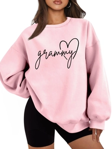 Detail of pink loose crewneck sweatshirt with grammy text and black heart pattern