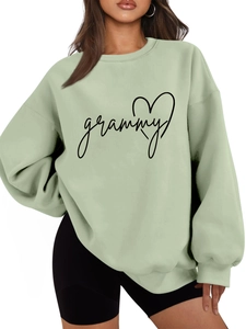 Detail of the soft mint green sweatshirt fabric featuring black grammy heart print