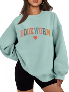 Detail of mint green fleece sweatshirt featuring colorful Bookworm print and red heart