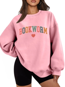 Close-up of light pink sweatshirt featuring retro BOOKWORM text and red heart graphic