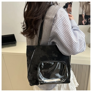 Detail of black large capacity tote bag with transparent PVC window for display