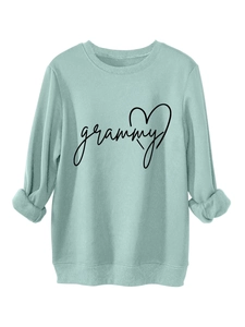 Detail of mint green sweatshirt with grammy heart print and ribbed knit texture