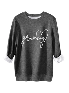 Detail of soft white fleece lining and grammy heart print on dark grey sweatshirt
