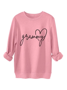 Detail of pink crewneck sweatshirt featuring black grammy lettering and heart graphic print