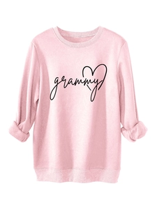 Close-up of pink long-sleeve sweatshirt featuring rib-knit collar and grammy heart print